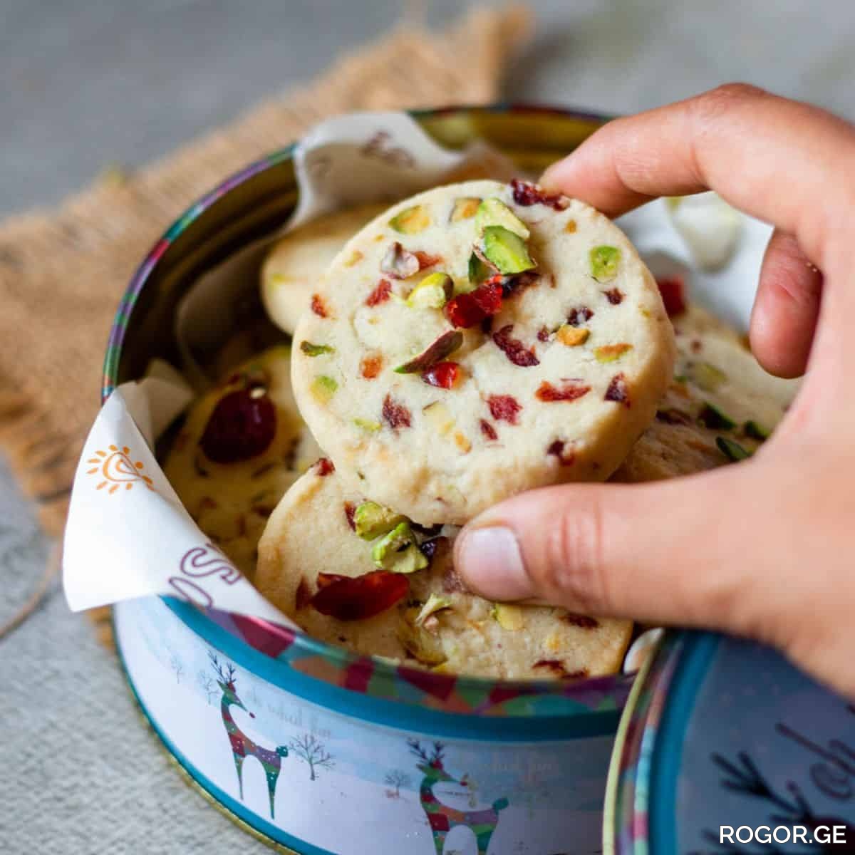 close-up-image-of-picking-cranberry-pistachio-shortbread-cookies-1771577733.jpg