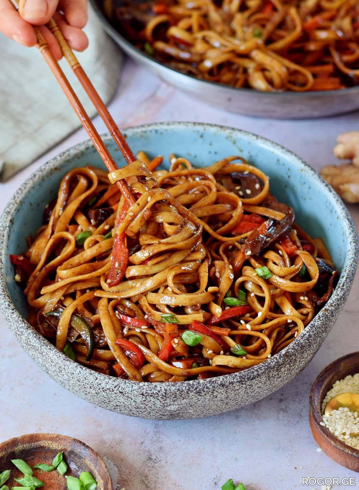eating-vegetable-stir-fry-noodles-with-chopsticks-1780907051.jpg